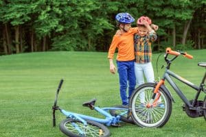 Zwei Jungen mit Fahrradhelmen und Rädern